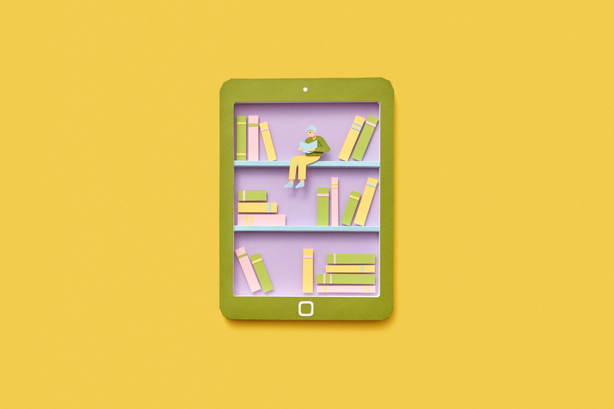 Paper tablet with bookshelf handmade from colored paper on a yellow background